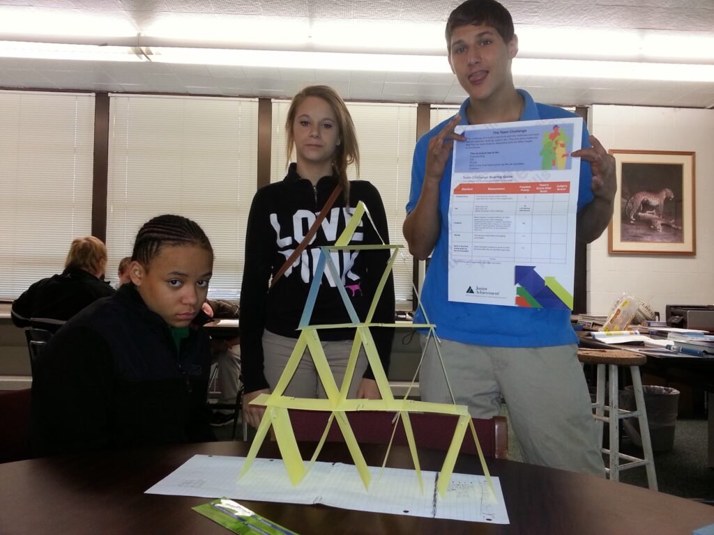 Young participants present a hands-on prototype during a classroom team challenge.
