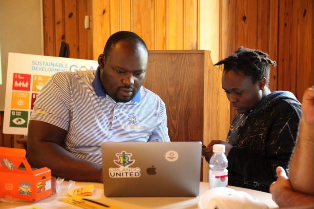 Patrick Odoyo mentors a participant during a collaborative learning session.